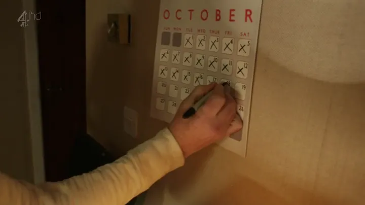 Una mano tacha los días de un calendario de octubre en Black Mirror