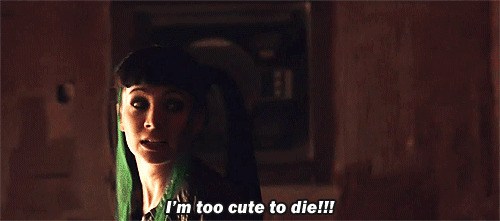 Kenzi asomada por una puerta con el subtítulo «I’m too cute to die!!!» en Lost Girl